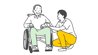 従業者が車椅子に乗っている高齢者に寄り添う様子
